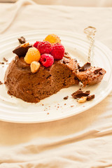 Chocolate mousse with raspberries.The process of eating.