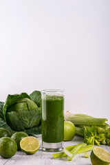 Healthy green smoothie with straw in a jar mug on white background. Copy space.