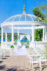 white gazebo and wedding ceremony. Lake shore