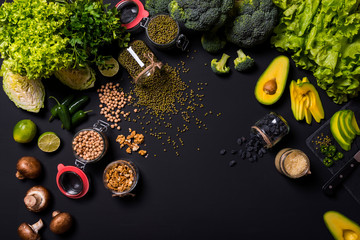Set of vegan vegetables and fruits on black background. Flat lay
