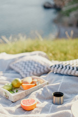 Picnic on the grass on mountain over sea view on summer day. Relaxing on nature.