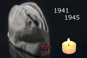 May 9! Russia victory day. Military cap on a black background. Remember Like Proud inscription in Russian.
