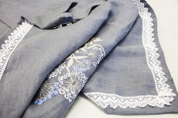 carelessly thrown duvet cover made of natural linen with machine embroidery and white cotton lace....