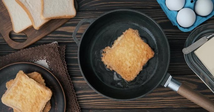 Cinemagraph - Cooking french toast in a frying pan. Top view.  Motion Photo. 