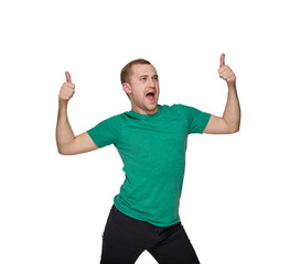 Fototapeta premium A funny young man in a green shirt shows two likes