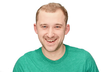 A funny young man in a green shirt shows happy