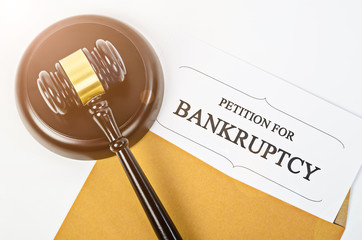 Bankruptcy document with wooden gavel.