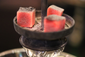 Lighted hookah coals close up.