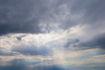 sun rays push through the dense clouds