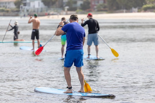 men paddling in the ocean