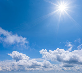 Naklejka na ściany i meble sparkle sun on the blue cloudy sky, natural background
