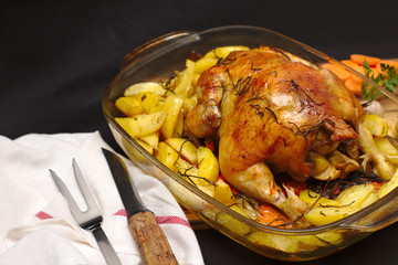 oven-baked crispy crust stuffed chicken on a plate with potatoes and apples