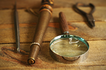 Diamond ring, magnifying glass and tools