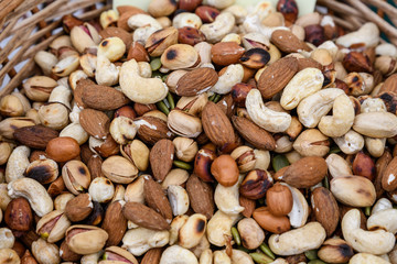 Close up of mixed nuts available for sale at a food market, fried salted pistachio, cashew, almonds and peanuts