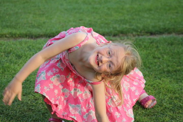 little girl playing on the grass