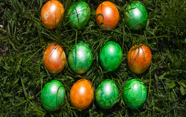 Fototapeta na wymiar Easter composition with colorful Easter eggs and spring flowers on wooden background. Easter card with copy space.