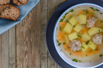 Vegetable soup with chicken cutlets and pieaces of homemade bread.Top view with copy space.
