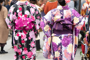 Young girl wearing Japanese kimono standing in front of Sensoji Temple in Tokyo, Japan. Kimono is a Japanese traditional garment. The word "kimono", which actually means a "thing to wear"