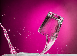 flying falling and smashing glass shot glass for vodka on a red gradient background, fragments and splashes
