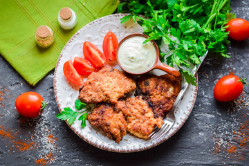 Fried portion chicken with greens and fresh vegetables.