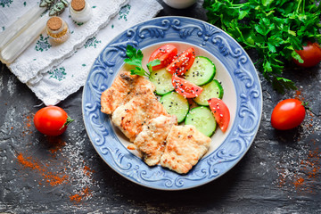  Fried pork with fresh cucumbers and tomatoes.