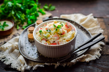 Salad with crab sticks, rice and fresh vegetables.