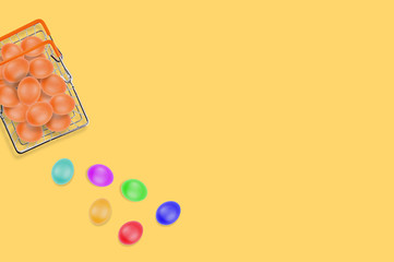 One full glossy metal market basket of fresh raw brown eggs on yellow table on kitchen. Top view. Business concept. Copy space for your text