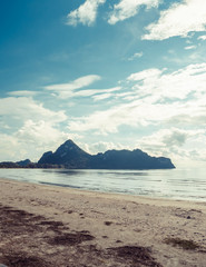 Fototapeta na wymiar Relaxing seascape tropical paradise beach with white sand and island in the sea.