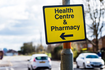 farmacy health centre directional road sign on road in uk