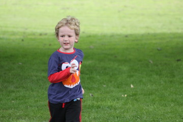 Little boy running on the grass