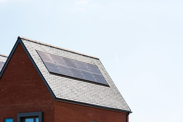 solar panels on roof of new houses in england uk on bright sunny day