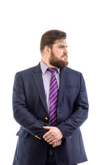 face profile portrait of a big handsome serious bearded business man in a dark suit, isolated on white