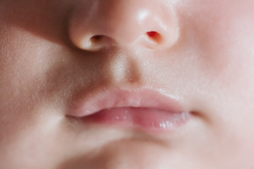Fototapeta premium close up view of baby mouth. Baby and family concept