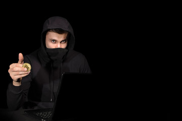Hacker with laptop and bitcoin initiating cyber attack, isolated on black