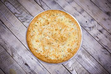 A whole big pizza close-up on a gray background. Colorful pizza topping closeup