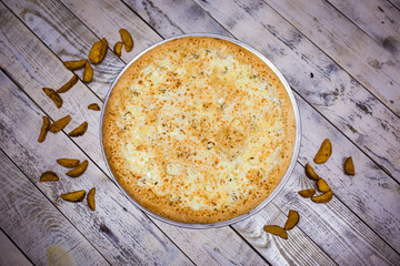 A whole big pizza close-up on a gray background. Colorful pizza topping closeup