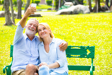 The happy elderly man and a woman making selfie