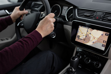 Close up of man using navigation in his car