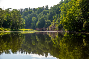 Obraz premium Landscape with river, cliff and forest in Latvia.