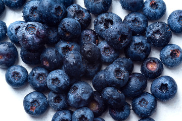 Macro shot of fresh ripe blueberries on white background