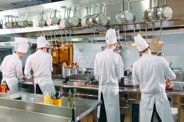 Modern kitchen. Cooks prepare meals on the stove in the kitchen of the restaurant or hotel. The...