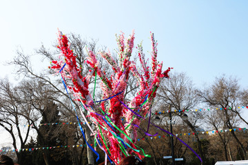 A tree decorated with artificial flowers