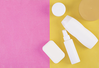 Set cosmetics SPA.  Mockup on pink-yellow background, place you design. Top view