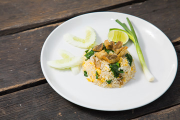 Fried rice with Fried Fish on the wooden table from top view