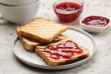 toasts with jam. fried crispy toasts with red jam on a light concrete table. breakfast.