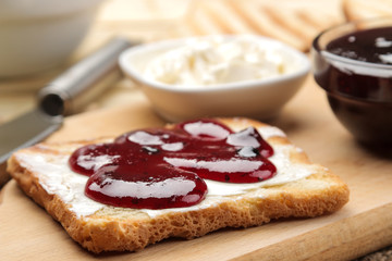 toasts with jam. fried crispy toast with red jam on a natural wooden table. breakfast. close-up
