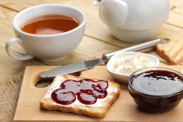Fototapeta na wymiar toasts with jam. fried crispy toast with red jam on a natural wooden table. breakfast.