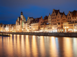Fototapeta na wymiar Old town in Gdansk, Poland, at night. Promenade and city light reflections.