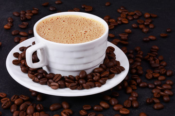 Cup of hot coffee on black background