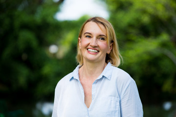 Portrait of older woman smiling natural light in  park